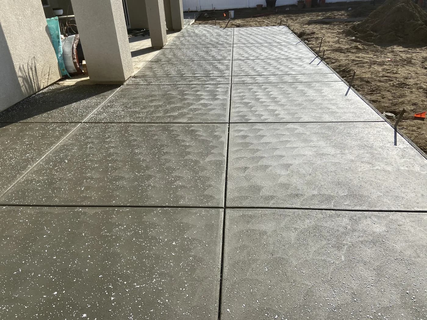 Stamped concrete patio with a scalloped texture and salt finish